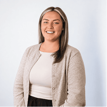 Smiling woman in professional attire for about us page.