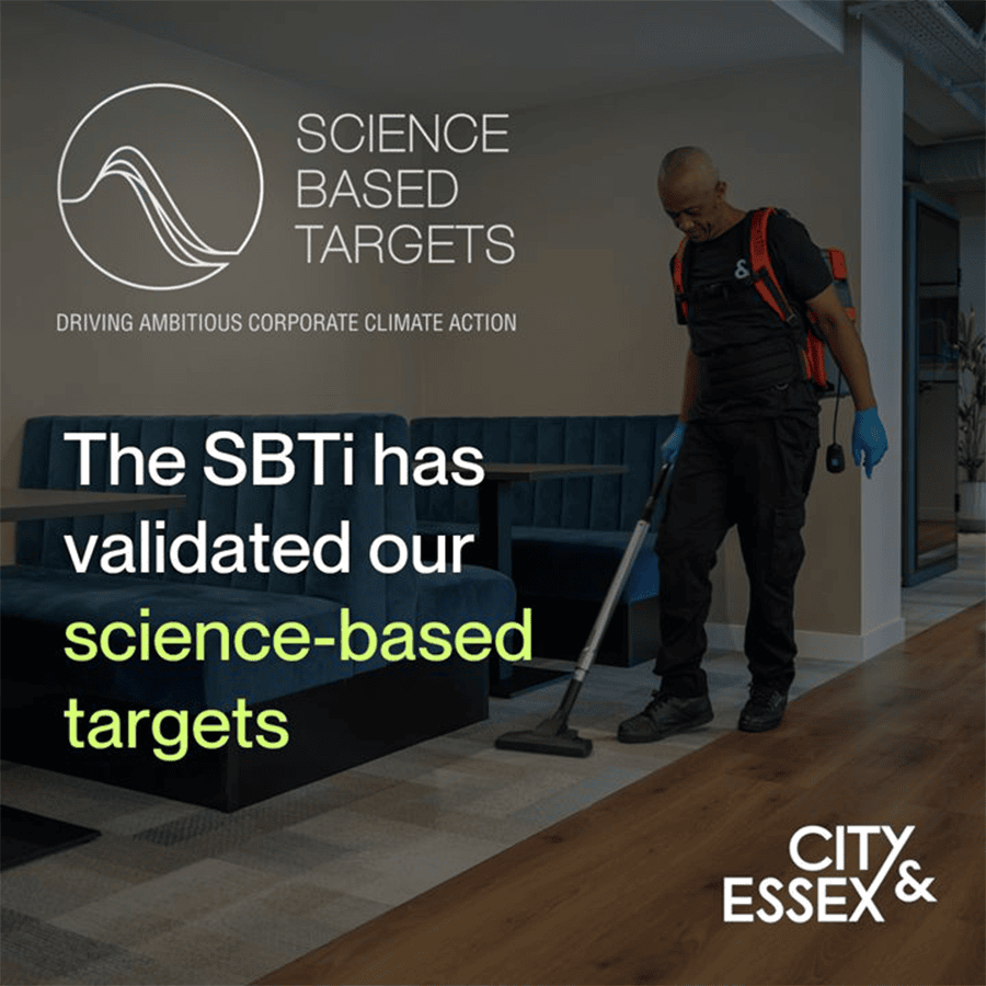 Man cleaning floor in office with SBTi science-based targets display.